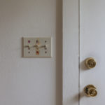 2 of 15 images. The photograph depicts a lightswitch with permanent marker and tape residue marking the switches.