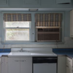 3 of 15 photographs. The photograph depicts a midcentury, powder-blue kitchen.